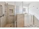 Accessible bathroom features a walk-in shower with grab bars, a walk-in tub, and tiled walls and marble floors at 1911 Hobson Dr, Henderson, NV 89074