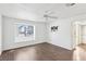 Light and airy bedroom features wood floors, ceiling fan and view of the street at 1911 Hobson Dr, Henderson, NV 89074