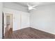 This bedroom features laminate flooring, a ceiling fan, ample natural light, and closet access at 1911 Hobson Dr, Henderson, NV 89074