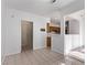 Hallway featuring an open entrance to the kitchen, white paint and tile floors at 1911 Hobson Dr, Henderson, NV 89074