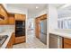 Bright kitchen features wooden cabinets, stainless steel appliances, and tiled floors at 1911 Hobson Dr, Henderson, NV 89074