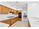 Traditional kitchen features wooden cabinets, white countertops, tile floors, and modern appliances at 1911 Hobson Dr, Henderson, NV 89074