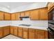 Traditional kitchen with wooden cabinets, white tile countertops, and a gas cooktop at 1911 Hobson Dr, Henderson, NV 89074