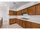 Bright kitchen with wood cabinetry, tiled countertops and backsplash, and recessed lighting at 1911 Hobson Dr, Henderson, NV 89074