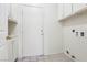 Bright laundry room with tile floors features storage cabinets and utility connections at 1911 Hobson Dr, Henderson, NV 89074