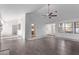 Living room featuring vaulted ceilings, wood laminate floors, and access to kitchen and entryway at 1911 Hobson Dr, Henderson, NV 89074