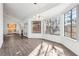 Bright living room featuring wood floors, vaulted ceiling, and large windows at 1911 Hobson Dr, Henderson, NV 89074