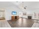 Bright living room features wood floors, ceiling fan, fireplace, and sliding doors to the exterior at 1911 Hobson Dr, Henderson, NV 89074