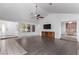 Bright living room with vaulted ceilings, tile entry, laminate wood flooring, and open access to kitchen at 1911 Hobson Dr, Henderson, NV 89074