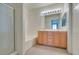 Bathroom with double sinks, vanity and tub with glass shower door at 205 Crown Imperial St, Henderson, NV 89074