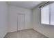 Neutral bedroom featuring a window for natural light and a closet with panel doors at 205 Crown Imperial St, Henderson, NV 89074