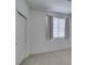 Bedroom featuring a window with decorative curtains and a closet with panel doors at 205 Crown Imperial St, Henderson, NV 89074