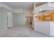 Expansive living room with kitchen view, carpet flooring, and neutral color palette at 205 Crown Imperial St, Henderson, NV 89074