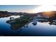 Aerial view of a golf course, luxury residences, and a yacht docked along the tranquil waterfront at 22 Barrio Alto Ct, Henderson, NV 89011