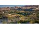 Panoramic view of luxury homes nestled in a scenic landscape with mountains, a lake, and lush greenery at 22 Barrio Alto Ct, Henderson, NV 89011