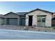 New single-story home with a stone facade and two-car garage with brick paver driveway at 22 Barrio Alto Ct, Henderson, NV 89011