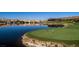 Scenic golf course view alongside a lake, with players on the green and luxury residences in the backdrop at 22 Barrio Alto Ct, Henderson, NV 89011