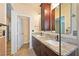 Well lit bathroom with double granite vanity and glass shower enclosure at 2213 Midvale Ter, Henderson, NV 89074