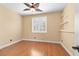 Bedroom featuring wood floors, ceiling fan, plantation shutters, and warm paint at 2213 Midvale Ter, Henderson, NV 89074