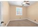 Empty bedroom featuring carpeting, ceiling fan, plantation shutters, and light paint at 2213 Midvale Ter, Henderson, NV 89074