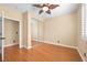 Empty bedroom with wood floors, ceiling fan, plantation shutters, and mirrored closet at 2213 Midvale Ter, Henderson, NV 89074