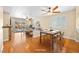 Bright, staged dining room with wood floors, table setting, and view into the backyard at 2213 Midvale Ter, Henderson, NV 89074