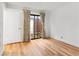 Bedroom with wood-look floors, a sliding glass door with curtains and a white closet door at 2620 San Martin Ct, Las Vegas, NV 89121