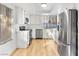 Modern kitchen with stainless steel appliances, white cabinetry, and hardwood floors at 2620 San Martin Ct, Las Vegas, NV 89121