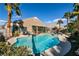 Backyard oasis featuring a sparkling pool, lounge chairs, swaying palm trees, perfect for relaxation and entertainment at 2713 Tanagrine Dr, North Las Vegas, NV 89084