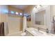 Bathroom view featuring a framed mirror, a shower/bath with a curtain, and granite countertops at 2713 Tanagrine Dr, North Las Vegas, NV 89084