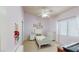 A cozy bedroom with a lavender palette, complemented by a white bed, dresser, and a ceiling fan at 2713 Tanagrine Dr, North Las Vegas, NV 89084