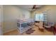 Shared bedroom featuring a bunk bed, soft green walls, complemented by a cozy rug, and a reading chair at 2713 Tanagrine Dr, North Las Vegas, NV 89084