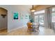 Bright dining area with light wood table, surrounded by colorful travel themed posters at 2713 Tanagrine Dr, North Las Vegas, NV 89084