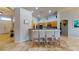 Inviting kitchen featuring a breakfast bar with four upholstered chairs and wood cabinetry at 2713 Tanagrine Dr, North Las Vegas, NV 89084