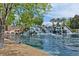 Scenic view of the community pond featuring a rock waterfall feature and waterfront vegetation at 2713 Tanagrine Dr, North Las Vegas, NV 89084