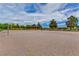 Outdoor sand volleyball court ready for play, surrounded by greenery, under a bright, partly cloudy sky at 2713 Tanagrine Dr, North Las Vegas, NV 89084