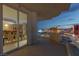 Balcony connecting to an indoor kitchen dining area, overlooking a vibrant cityscape at dusk at 2747 Paradise Rd # Ph 3604, Las Vegas, NV 89109