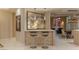 Wet bar area features stone accents, a marble countertop and modern barstools at 2747 Paradise Rd # Ph 3604, Las Vegas, NV 89109