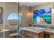 Spa-like bathroom featuring a stylish soaking tub, sleek vanity, and a round window capturing breathtaking mountain views at 2747 Paradise Rd # Ph 3604, Las Vegas, NV 89109