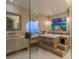 Modern bathroom with stylish soaking tub, sleek vanity, and walk-in shower, complemented by a round window offering scenic vistas at 2747 Paradise Rd # Ph 3604, Las Vegas, NV 89109