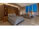 Comfortable bedroom features a Murphy bed, sitting area, and a stunning view of the Las Vegas strip through a large window at 2747 Paradise Rd # Ph 3604, Las Vegas, NV 89109