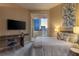Bedroom with balcony, desk, and painting above headboard at 2747 Paradise Rd # Ph 3604, Las Vegas, NV 89109