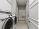 Bright laundry room features a front-load washer and dryer, white cabinets, and tile flooring at 2747 Paradise Rd # Ph 3604, Las Vegas, NV 89109