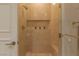 Modern shower features beige tile, glass door, built-in niche, and a bench at 2747 Paradise Rd # Ph 3604, Las Vegas, NV 89109