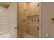 Tiled shower features glass door, gold hardware, built-in niche, grab bar, and a rain shower head at 2747 Paradise Rd # Ph 3604, Las Vegas, NV 89109
