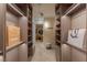 Bright walk-in closet with custom shelving, drawers, and a stylish ottoman, perfect for organizing and showcasing apparel at 2747 Paradise Rd # Ph 3604, Las Vegas, NV 89109