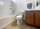 Clean bathroom featuring a shower-tub combo, toilet, and wood vanity with a sink at 2756 Blairgowrie Dr, Henderson, NV 89044