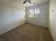 Bright bedroom with carpet flooring, ceiling fan, and shuttered windows at 2756 Blairgowrie Dr, Henderson, NV 89044