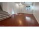 Spacious living room featuring hardwood floors, natural light from window, and entry to staircase at 2756 Blairgowrie Dr, Henderson, NV 89044