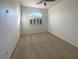 Empty main bedroom with carpet, an arched window, and neutral decor at 2756 Blairgowrie Dr, Henderson, NV 89044